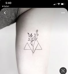 a black and white photo of a flower tattoo on the left side of a woman's arm