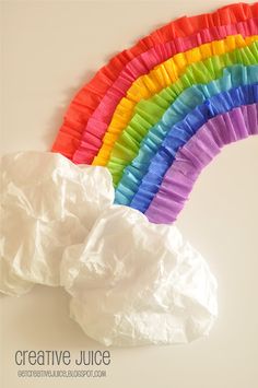 tissue paper rainbows are on the table