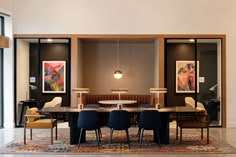 a dining room table with four chairs around it and an area rug on the floor