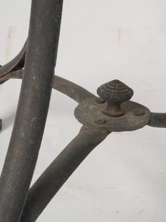 an old wrought iron bed frame with rusted metal posts and knobs on it