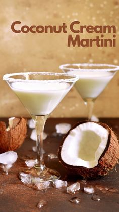 two martini glasses filled with coconut cream and garnished with powdered sugar next to an open coconut