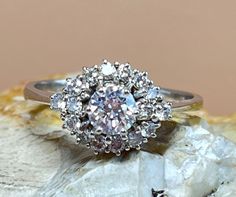 a diamond ring sitting on top of a rock