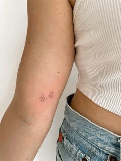 a woman with a small tattoo on her arm