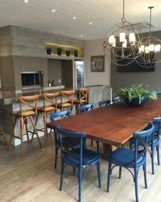 a large wooden table surrounded by blue chairs