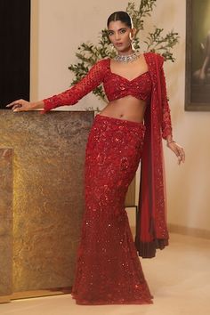 Red mermaid lehenga featuring all over floral hand embroidery with shimmering beads, sequins and thread work. Paired with a padded blouse and coordinating dupatta., Fit: Relaxed Red Wedding Saree With Intricate Embroidery, Red Wedding Pre-draped Saree With Intricate Embroidery, Red Party Wear Lehenga With Intricate Embroidery, Designer Red Sequined Sets, Fitted Red Traditional Party Wear, Red Sequined Sharara With Traditional Drape, Red Party Wear Pre-draped Saree With Resham Embroidery, Party Wear Red Choli With Intricate Embroidery, Red Fitted Saree For Party Wear