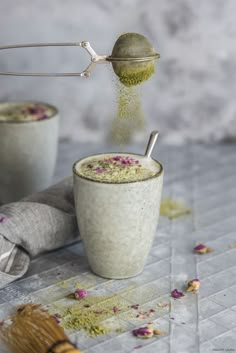 two cups filled with green tea and sprinkles