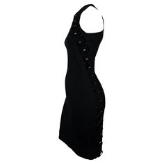 This Spring/Summer 2010 Gucci bodycon dress by Frida Giannini is crafted from black stretch fabric in a sleeveless, fitted silhouette. It features bungee-inspired lace-up detailing along the sides and upper chest, accented with silver-tone hardware. A concealed back zipper completes the streamlined design. Vogue described this "glam, atheletic, almost sci-fi" collection as "the best Giannini has done." Approximate measurements: Size - S Bust: 30" - 32" Waist: 24" - 28" Hips: 30" - 36" Shoulder t Vintage Cocktail Dresses, Cocktail Dress Vintage, Evening Dresses Cocktail, Vintage Cocktail, Fitted Silhouette, Black Stretch, Primavera Estate, Cocktail Dresses, Stretch Fabric