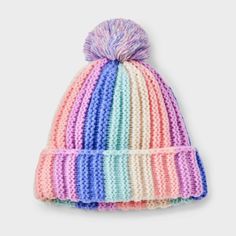 a multicolored knitted hat with a pom - pom