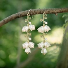 Adorn yourself with the elegance of these exquisite Lily of the Valley earrings. Crafted in precious metals, these statement pieces feature detailed petals and exquisite craftsmanship that will bring a touch of luxury to any look. Perfect for an evening out or to add a hint of glamour to your everyday style. DETAILS Plating: 18k Gold Materials: 18k Gold On Brass, Cubic Zirconia, Silver Size: 2.40"*0.47"(61mm*12mm) Weight: 6.50g/pr There will be a little difference among different production batches of products due to the variation of natural materials. Choose a lily of the valley exclusive gift box Witchy Wedding Accessories, Dangling Flower Earrings, Fairy Wedding Accessories, Ethereal Wedding Accessories, Elven Jewelry Earrings, Morning Glory Jewelry, Dangly Flower Earrings, Ethereal Wedding Jewelry, Jewellery Making Earrings