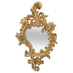 an ornate gold framed mirror on a white background