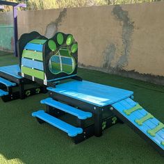 two children's playground equipment with blue and green paint on the top, one has a slide