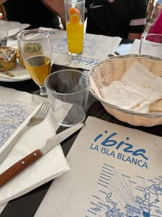 people sitting at a table with food and drinks