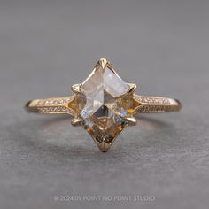 a yellow gold ring with two different colored stones