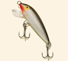 a fishing lure with red and yellow eyes