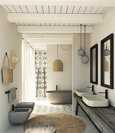 a bathroom with two sinks and mirrors on the wall next to a rug in front of it