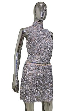 a mannequin with silver sequins on it's body and arms