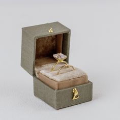 an open box with a ring in it