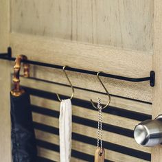 an umbrella is hanging on the wall next to two hooks and a door stopper