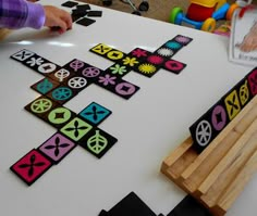 a child is playing with some sort of board game on the table in front of them