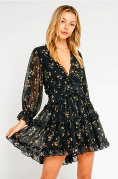 Update your semi-formal look with the Air of Romance Navy Floral Print Dress! This plunging v-neckline, attached sheer long sleeves ruffle tiered skirt forms this one of a kind mini dress. Elastic ruffle cuffs and ruffle-trimmed cutout open back finishes the look. Chic V-neck Floral Dress For Date Night, Flirty Floral Mini Dress For Fall, Flirty Floral Print Mini Dress For Fall, Fitted V-neck Dress With Rose Print, Chic Fitted V-neck Floral Dress, Flirty V-neck Printed Dress, Date Night Mini Dress With Rose Print, Mini Dress With Rose Print For Date Night, Rose Print Mini Dress For Date Night