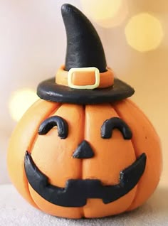 an orange pumpkin with a black hat on it