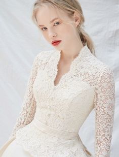 a woman is wearing a white dress and posing for the camera with her hands on her hips