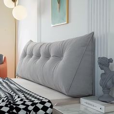 a bed that is in a room with some pillows on it