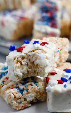 several pieces of cake with white frosting and sprinkles