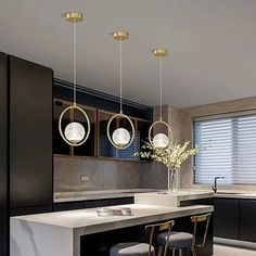 a modern kitchen with marble counter tops and bar stools