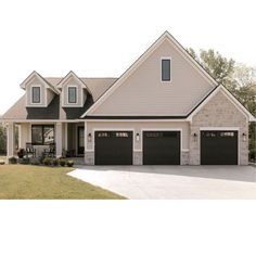 a large house with two garages and three windows