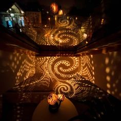 two vases sitting on top of a table in the middle of a dark room