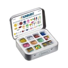 an open tin filled with different colored crayons and pencils on a white background