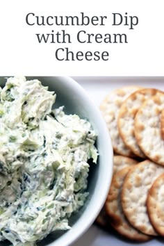 cucumber dip with cream cheese in a bowl and crackers on the side