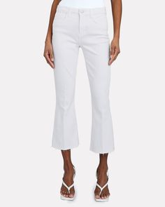 Fit Information:     High-rise.          Cropped flare silhouette.   Stretch denim.  Details:       Fabric: 93% cotton, 6% polyester, 1% spandex.   Machine wash cold.   Made in USA.   Model is 5'10" and wearing size 26.   Rise: 10".   Inseam: 26". High Rise White Flares For Spring, White Flare Jeans For Fall, White Cropped Leg Flare Jeans For Fall, White Cropped Flare Jeans For Fall, White Denim Flare Jeans With Frayed Hem, White Flare Denim Jeans, White High Rise Flare Jeans With Frayed Hem, White Flare Jeans With Frayed Hem, White Flare Jeans With Five Pockets