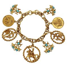 Vintage Gold and Faux Turquoise Charm Bracelet Circa 1980's. This charm bracelet features charms that have various coat of arms motifs. The pop comes from three arms that have faux turquoise and faux pearls which really pop against the gold. You can mix and match this with other pieces as well. A great piece. Turquoise Bohemian Jewelry With Vintage Charm, Vintage Gold Charm Bracelet Luxury, Vintage Charm Bracelet 1stdibs, Luxury Yellow Gold Vintage Charm Bracelet, Gold-tone Metal Charm Bracelet With Vintage Charm, Faberge Jewelry, Turquoise Charm, American Modern, Donna Karan