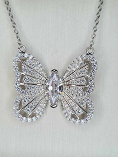 3.180ct. Cubic Zirconia Butterfly Necklace 925 sterling silver with Rhodium Overlay Hallmarked 925 solid sterling silver with a rhodium overlay  Chain size 20inches  Pendant size approx. 2cm from top wing to bottom wing Centre Stone White Cubic Zirconia Marquise 10x5mm Faceted Cut 1.500ct Exquisite Silver Diamond Cut Diamond Necklace, Exquisite Silver Diamond Cut Necklace, Exquisite Silver Diamond Necklace With Diamond Cut, Silver Diamond-cut Necklace, Exquisite Silver Diamond-cut Necklace, Exquisite Silver Necklace With Diamond Accents, Dazzling Sterling Silver Diamond-cut Jewelry, Dazzling Diamond Cut Sterling Silver Jewelry, Luxury Cubic Zirconia Pendant Jewelry