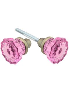 two pink glass knobs are shown with a screw in the middle and one has a metal head