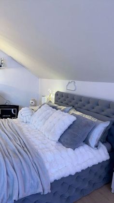 a large bed sitting in the middle of a bedroom