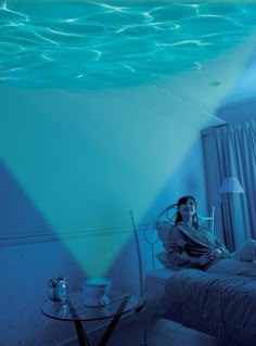 a woman laying on top of a bed under water