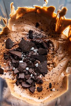 a blender filled with ice cream and chocolate chips in it's glass bowl