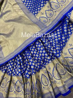 Dazzling royal blue Katan silk blend Banarsi saree. Dense gold  zari butas and tassels on the palla! Blouse fabric included. Fall attached. Note: The color of the products may slightly vary according to the lighting conditions and the color calibration of the viewing LED devices. If you would like more clarity before your purchase, please drop us a message . Royal Festive Dupatta With Traditional Drape, Royal Style Festive Dupatta With Traditional Drape, Royal Traditional Wear With Pallu For Eid, Royal Festive Dupatta, Royal Traditional Wear For Diwali In Traditional Drape, Royal Sets With Traditional Drape For Festive Occasions, Royal Festive Sets With Traditional Drape, Royal Traditional Wear For Diwali, Royal Traditional Wear For Eid