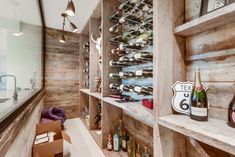 a wine cellar with wooden shelves filled with bottles