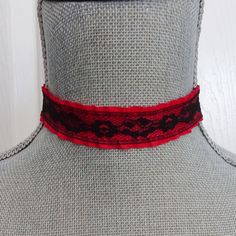 Red choker necklace is made up in a ruffled red fabric ribbon with a black lace overlay. The ribbon is crimped on the ends with black metal crimp bars and the choker measures 13" on the first link closure and with an extension chain allows for adjustable fit to 14 1/2 ". The extension chain is a matching black chain with a wire wrapped and linked black glass bead dangle on the end of the chain.  There is a black metal lobster claw closure on the choker. If you need another size just send me a message with your order and I can adjust the length for you. All of my jewelry items come boxed and ribbon tied and tagged for easy gifting.