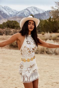 Go all out this festival season in the Like Gold Dust White Sequin Fringe Dress. The intricate pearl and sequin details on this piece will stand out amongst the crowd without a doubt. A great fit for any body type! PRODUCT DESCRIPTION AND MATERIALS: - sleeveless white sequin and pearl fringe dress - belt not included - button closure at the neck - zipper closure at the back - pearl details at neck and waist band - fishnet trim at hem and floral sequin embroidery - self, contrast, tassels: 100% p Cowgirl Shoot, Sequin Fringe Dress, Pearl Fringe, Cowgirl Dresses, Pearl Details, Sequin Crop Top, Sequin Embroidery, Crop Top Dress, Western Look