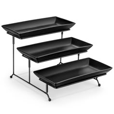 three black trays with metal legs on each side