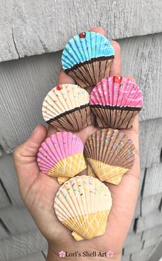 small seashells are held in the palm of someone's hand