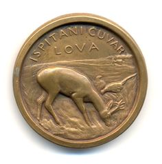 a bronze coin with an image of a cow on it's side and the words,