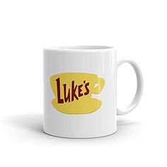 a white coffee mug with the words luke's on it in red and yellow