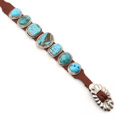 Admire the breathtaking grandeur of Danny Martinez's incredible Navajo bracelet. Seven shimmering turquoise stones, including a central one measuring 5/8" x 7/8", come together to create a mesmerizing fashion piece. This brown leather bracelet is fastened with a resplendent sterling silver buckle, adjustable to fit wrists up to 9" in circumference. The image shows the exact item that you will receive. Turquoise Leather Concho Bracelets, Southwestern Style Brown Concho Bracelets, Brown Western Leather Bracelet With Concho, Luxury Southwestern Kingman Turquoise Cuff Bracelet, Southwestern Turquoise Hand-strung Bracelets, Navajo Bracelet, Brown Leather Bracelet, Turquoise Leather, Turquoise Stones