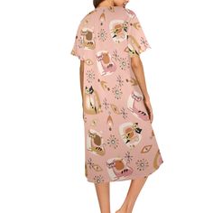 a woman wearing a pink dress with cats on it